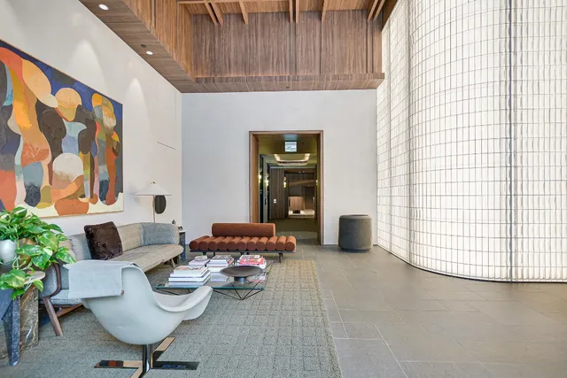 a living room with furniture and a potted plant