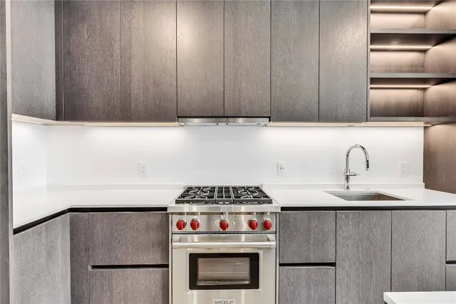 a kitchen with granite countertop a stove and a refrigerator