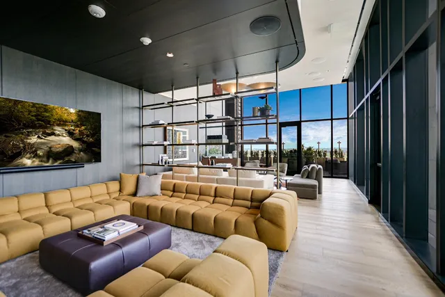 a living room with furniture a ceiling fan and a rug