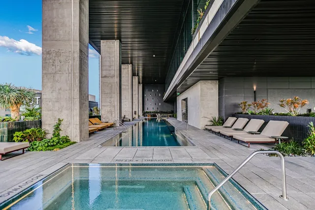 a view of a swimming pool with outdoor seating