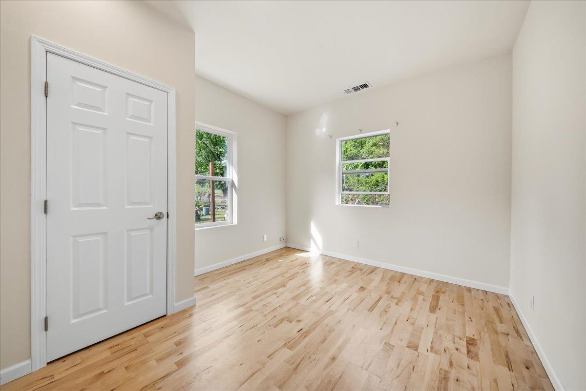 709 Cole Road Meadow Vista, CA 95722 - Photo 15 of 57 an empty room with wooden floor and windows