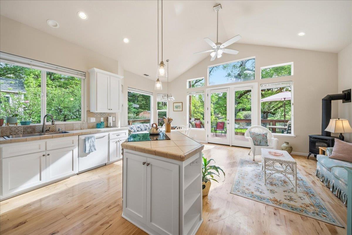 709 Cole Road Meadow Vista, CA 95722 - Photo 3 of 57 a large kitchen with kitchen island a large window a sink and cabinets