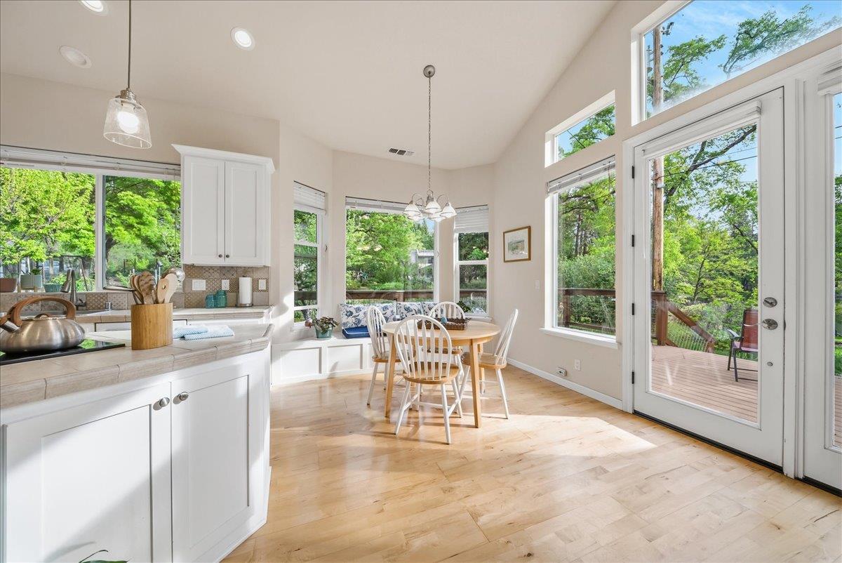 709 Cole Road Meadow Vista, CA 95722 - Photo 4 of 57 a dining room with wooden floor a chandelier a flat screen tv and a large window