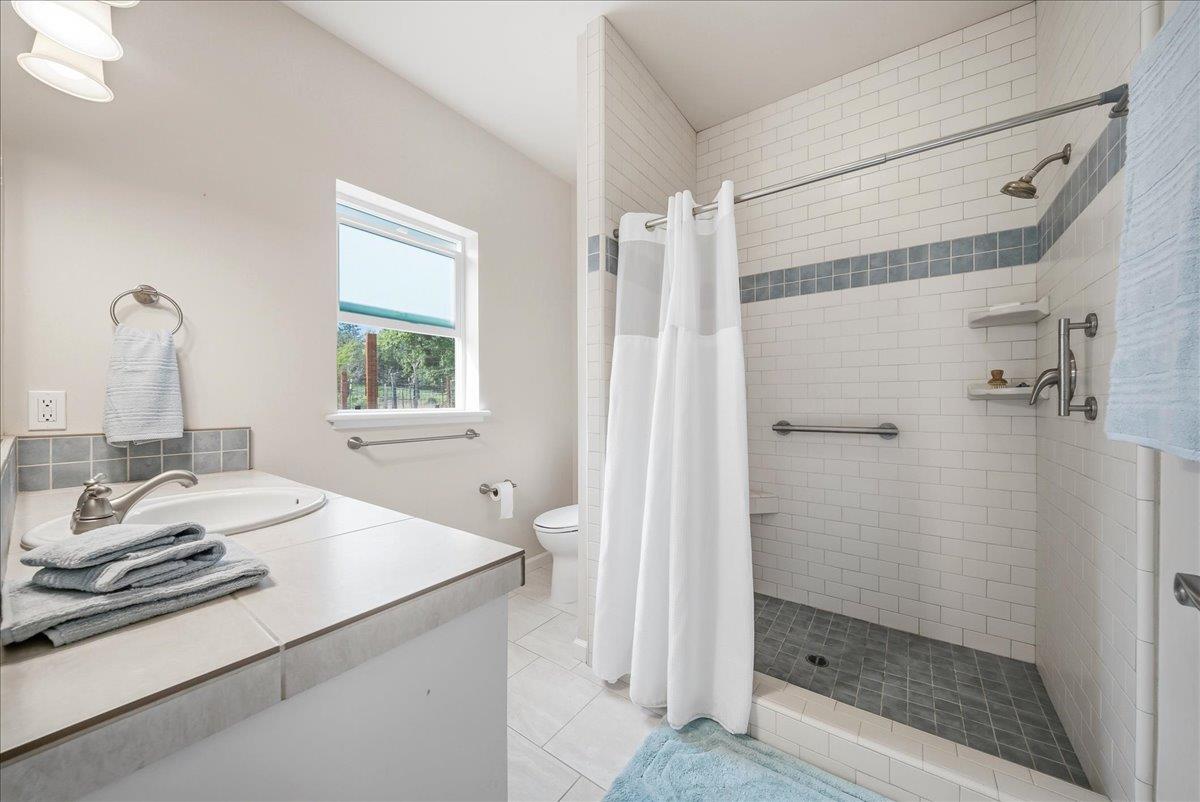 709 Cole Road Meadow Vista, CA 95722 - Photo 9 of 57 a bathroom with a granite countertop sink mirror and shower