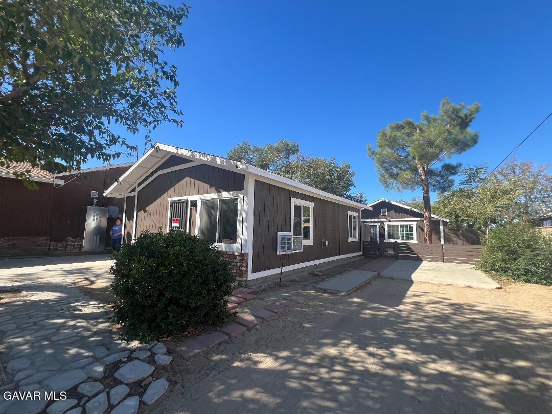 43119 7th Street East, Unit A 1/2 Lancaster, CA 93535 - Photo 1 of 11 a front view of a house with garden