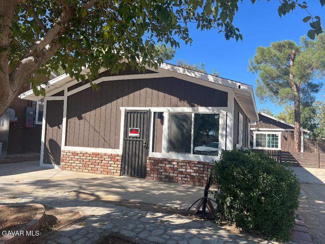 43119 7th Street East, Unit A 1/2 Lancaster, CA 93535 - Photo 2 of 11 a front view of a house with a yard