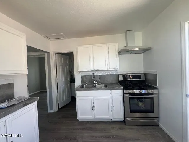 a kitchen with stainless steel appliances a stove and a refrigerator