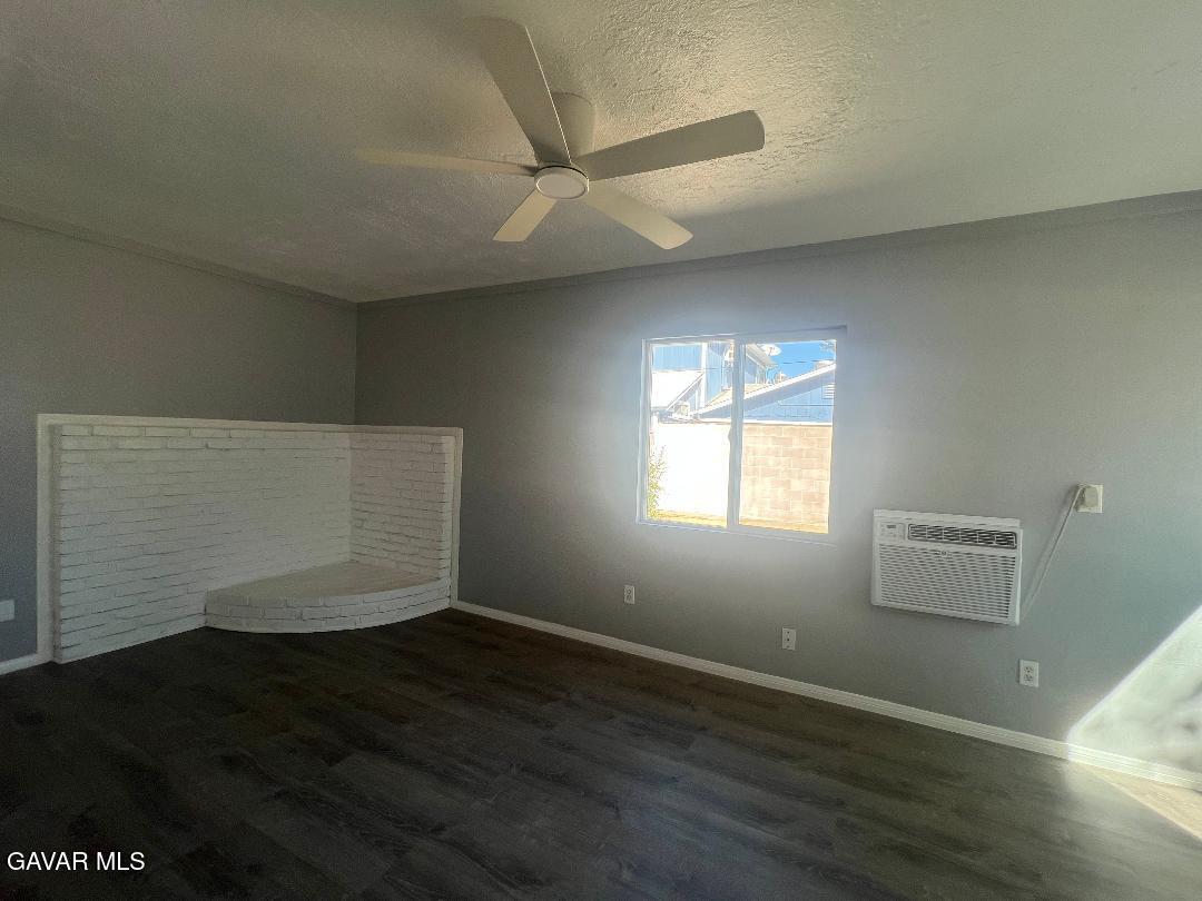 43119 7th Street East, Unit A 1/2 Lancaster, CA 93535 - Photo 7 of 11 an empty room with wooden floor and windows