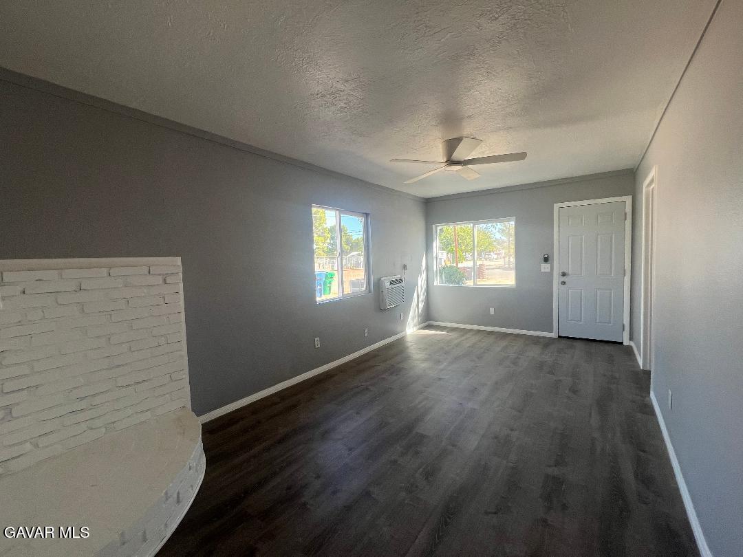 43119 7th Street East, Unit A 1/2 Lancaster, CA 93535 - Photo 8 of 11 a view of empty room with window and wooden floor