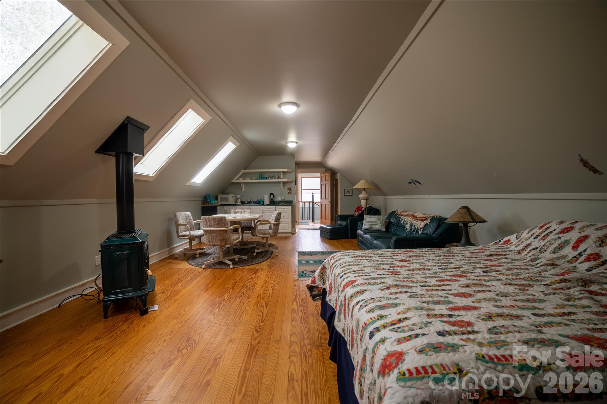 682 Rock House Road Hot Springs, NC 28743 - Photo 36 of 43 a bed room with a bed and a chair
