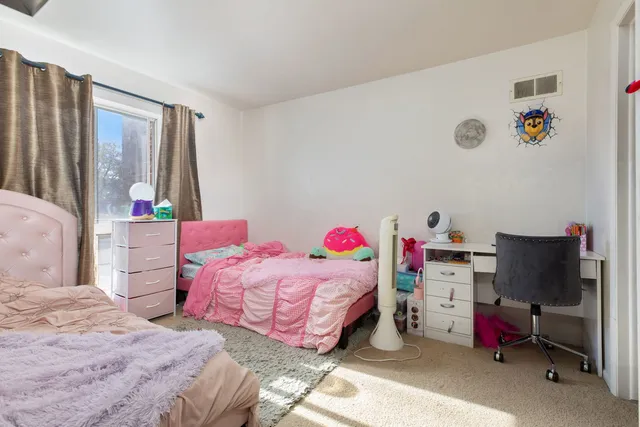 a bedroom with a bed and a desk