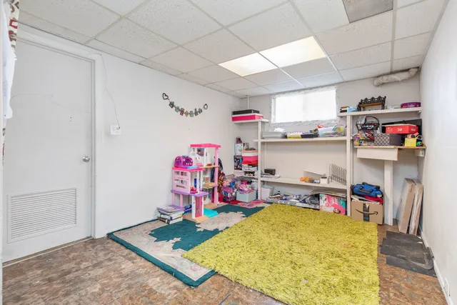 a storage room with washer and a table