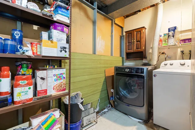a utility room with fridge dryer and washer