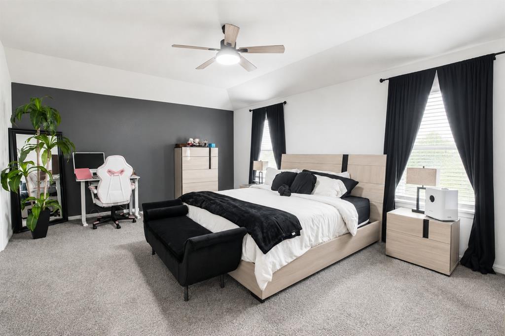 3204 Quiet Valley Road Fort Worth, TX 76123 - Photo 22 of 29 a spacious bedroom with a bed gym equipment and a large window