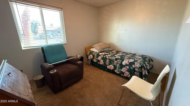 a bedroom with a bed and a chair