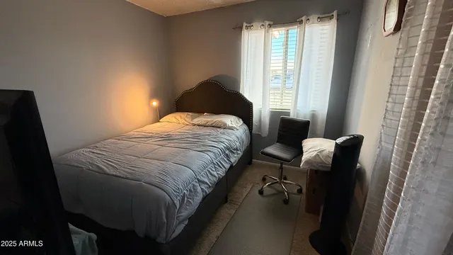 a bedroom with bed and window