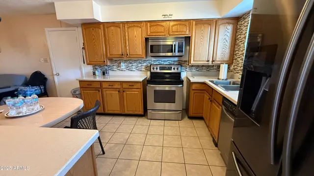 a kitchen with stainless steel appliances a stove microwave and cabinets