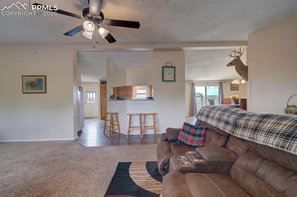 a living room with furniture and wooden floor