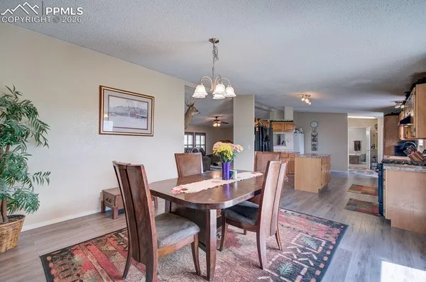 a view of a dining room with furniture wooden floor and a chandelier