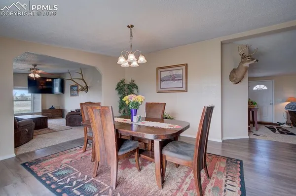 a view of a dining room with furniture and wooden floor