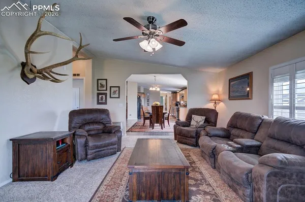 a living room with furniture and a chandelier