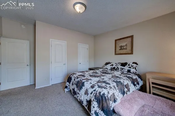 a bed sitting in a bedroom next to a window