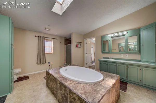 a bathroom with a granite countertop sink mirror and toilet