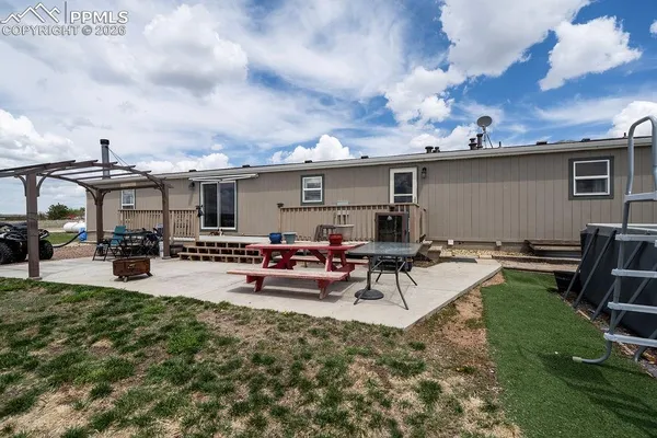 a view of a backyard with furniture and a garden