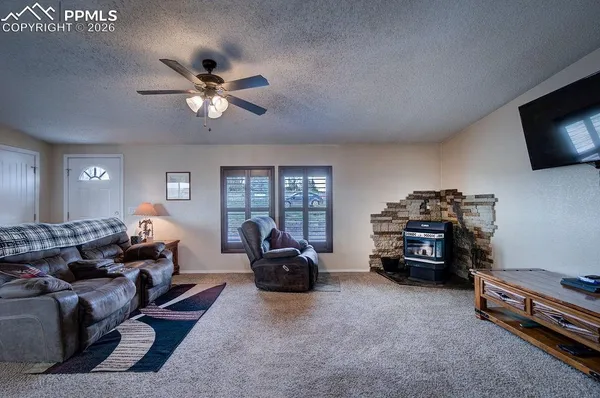 a living room with furniture a flat screen tv and a window