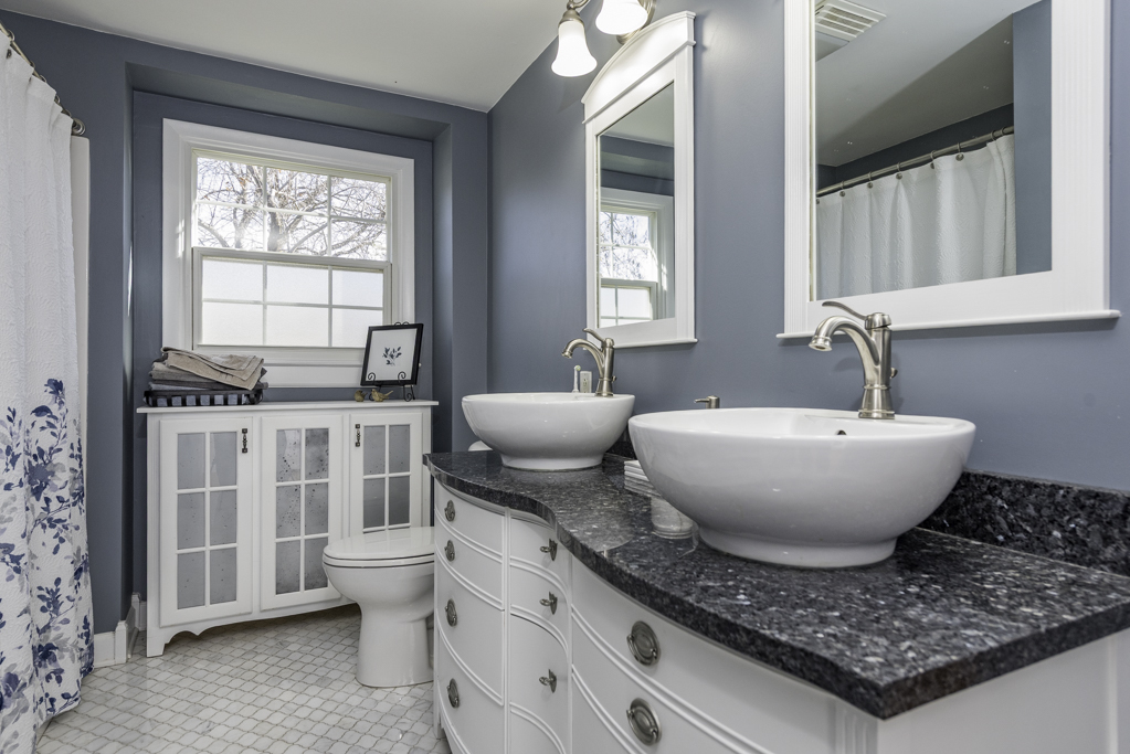 419 Northgate Road Lindenhurst, IL 60046 - Photo 13 of 23 a spacious bathroom with a granite countertop toilet a sink and a window