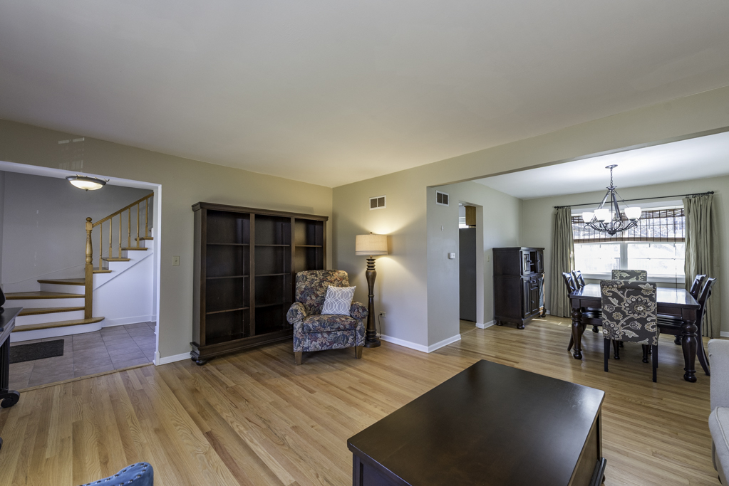 419 Northgate Road Lindenhurst, IL 60046 - Photo 2 of 23 a living room with furniture a wooden floor and next to a window