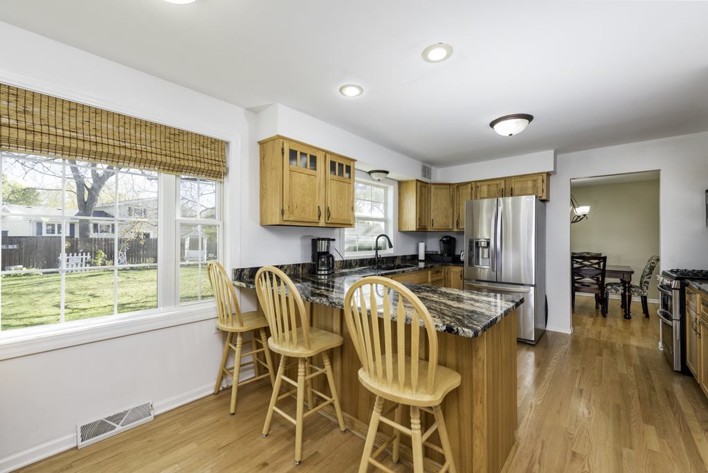 419 Northgate Road Lindenhurst, IL 60046 - Photo 7 of 23 a view of a dining room with furniture and wooden floor
