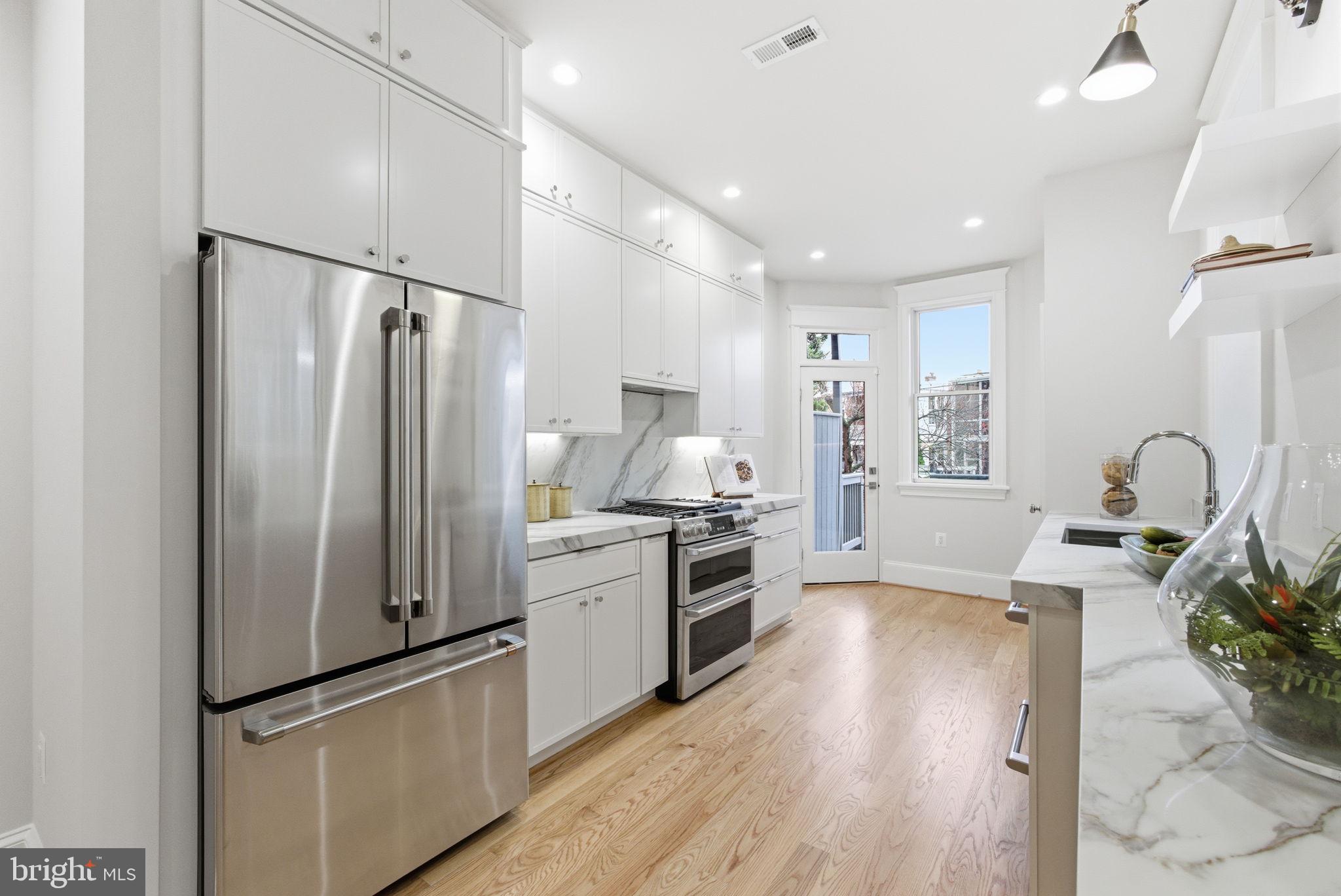 1319 East Capitol Street Southeast Washington, DC 20003 - Photo 13 of 46 a kitchen with stainless steel appliances granite countertop a refrigerator and a sink