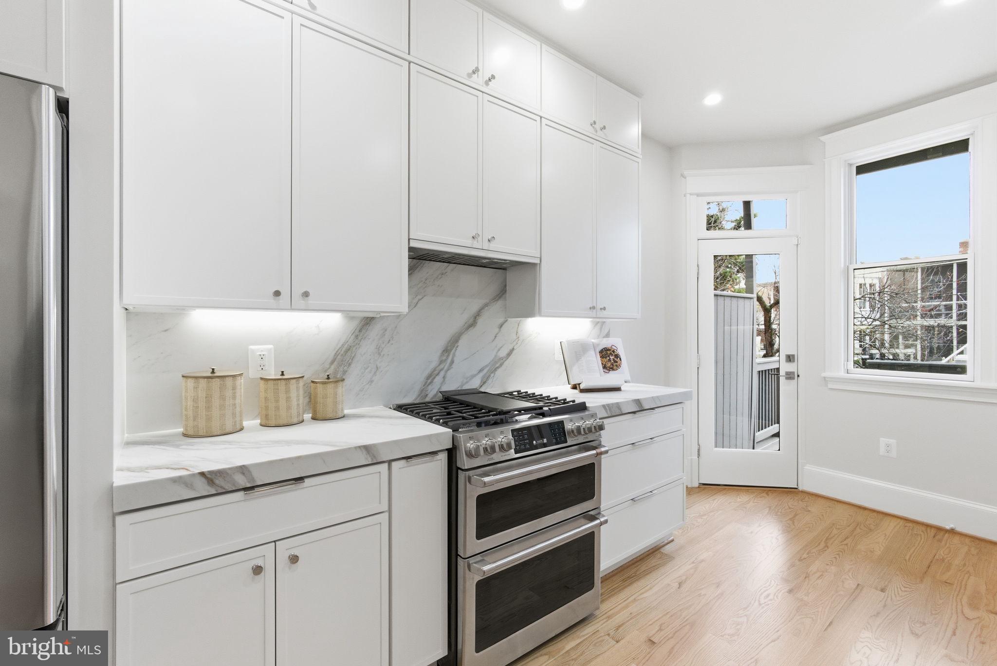 1319 East Capitol Street Southeast Washington, DC 20003 - Photo 14 of 46 a kitchen with granite countertop a stove and a sink