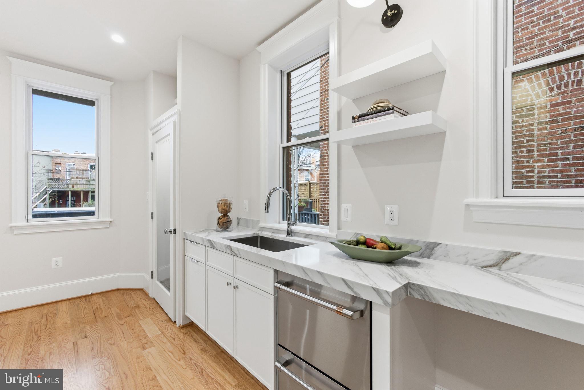 1319 East Capitol Street Southeast Washington, DC 20003 - Photo 16 of 46 a kitchen with a sink and cabinets