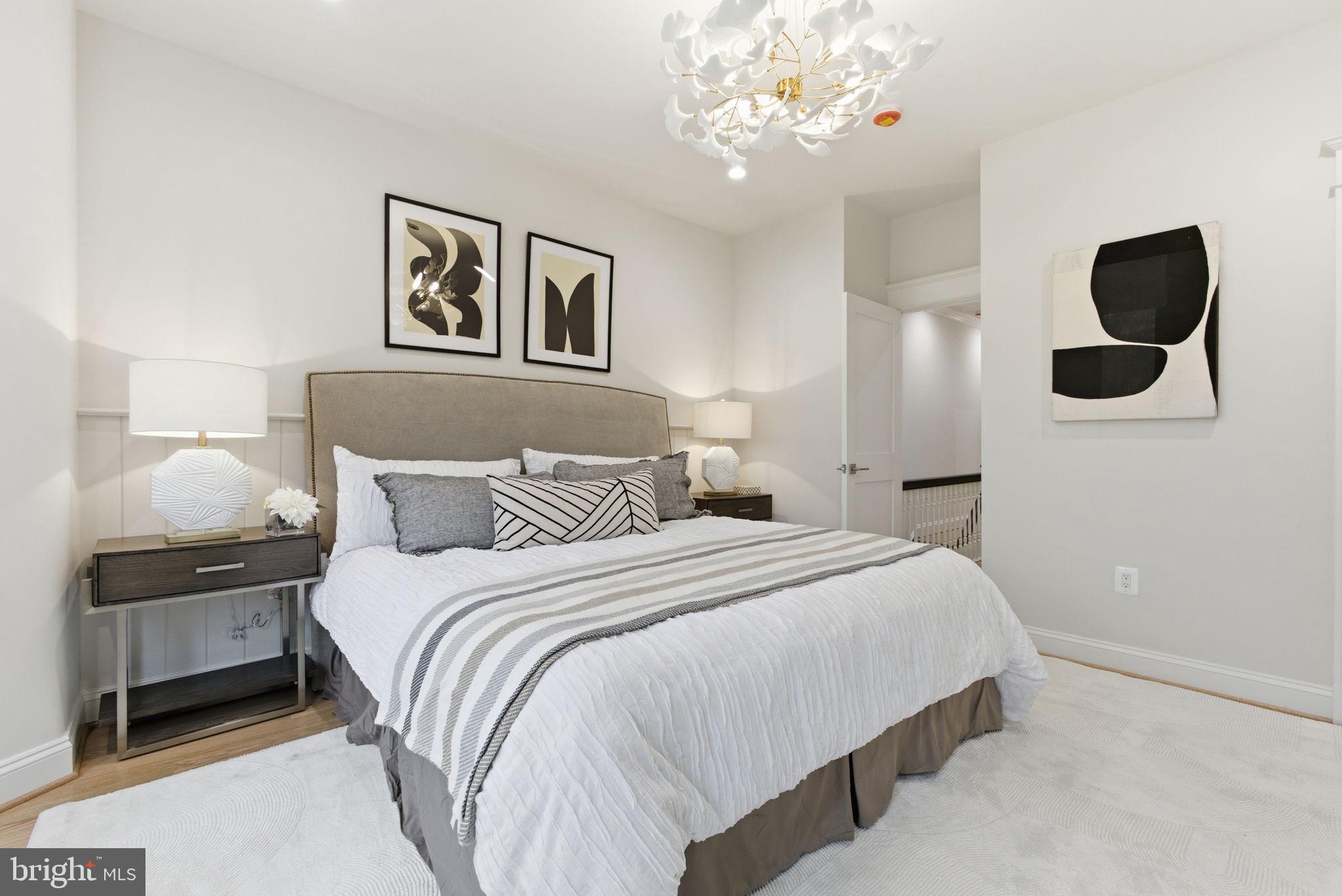 1319 East Capitol Street Southeast Washington, DC 20003 - Photo 19 of 46 a bedroom with bed and a chandelier