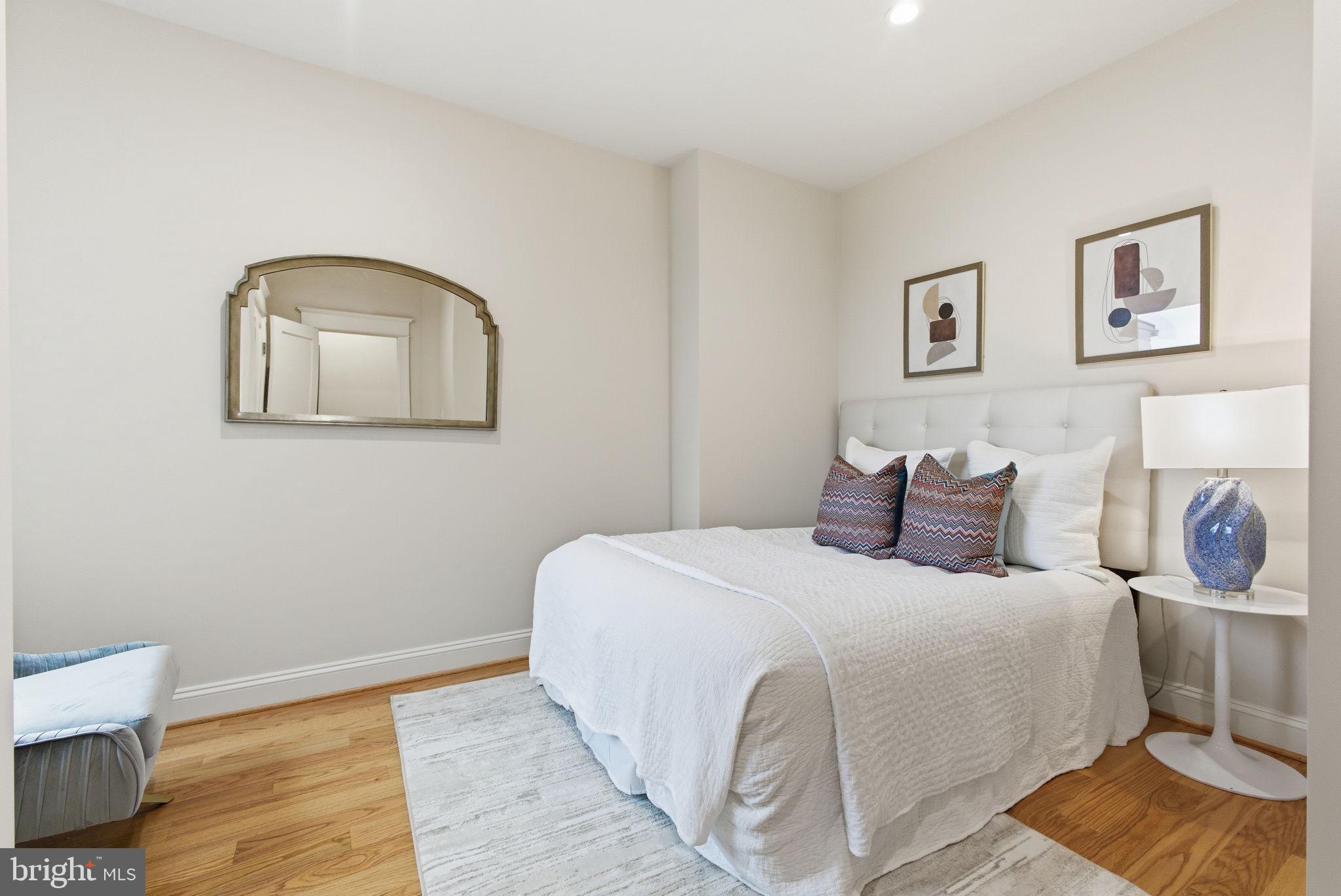 1319 East Capitol Street Southeast Washington, DC 20003 - Photo 24 of 46 a bedroom with a bed and wooden floor