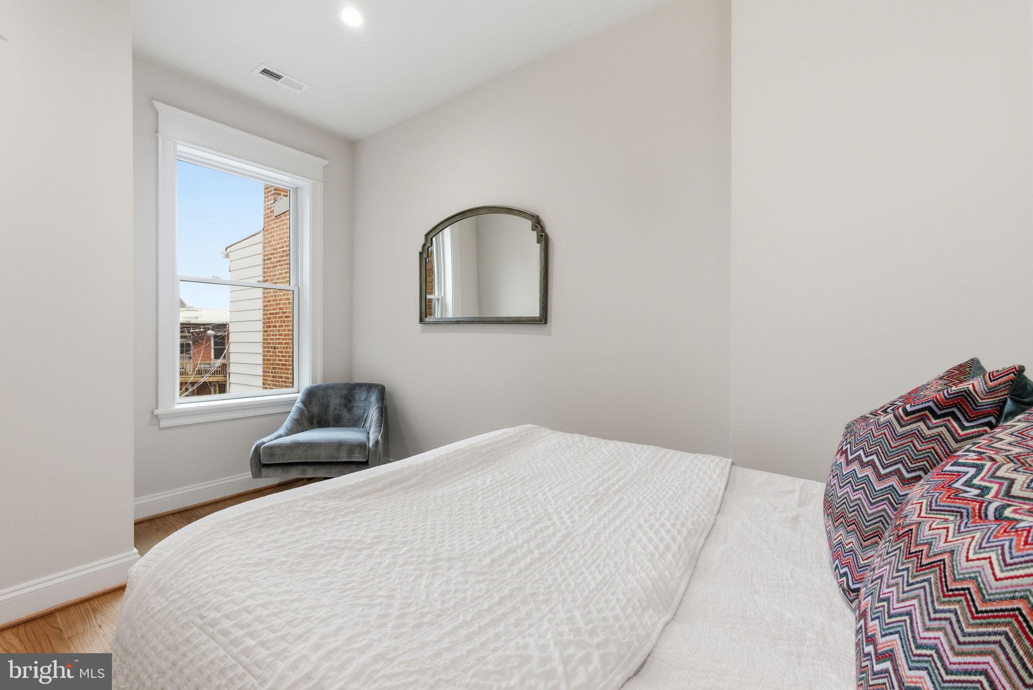 1319 East Capitol Street Southeast Washington, DC 20003 - Photo 25 of 46 a bedroom with a bed and a window