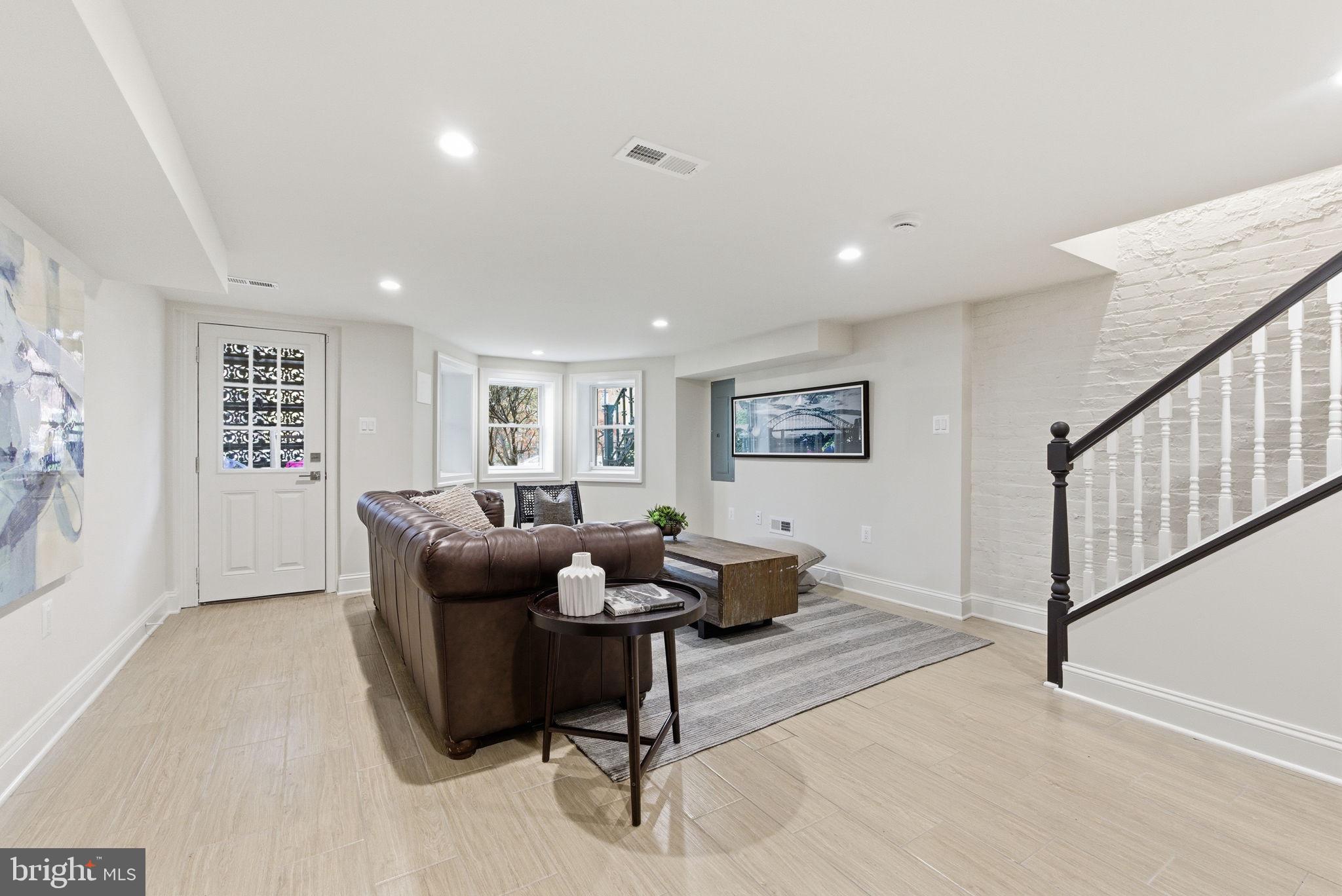 1319 East Capitol Street Southeast Washington, DC 20003 - Photo 30 of 46 a living room with furniture and a wooden floor