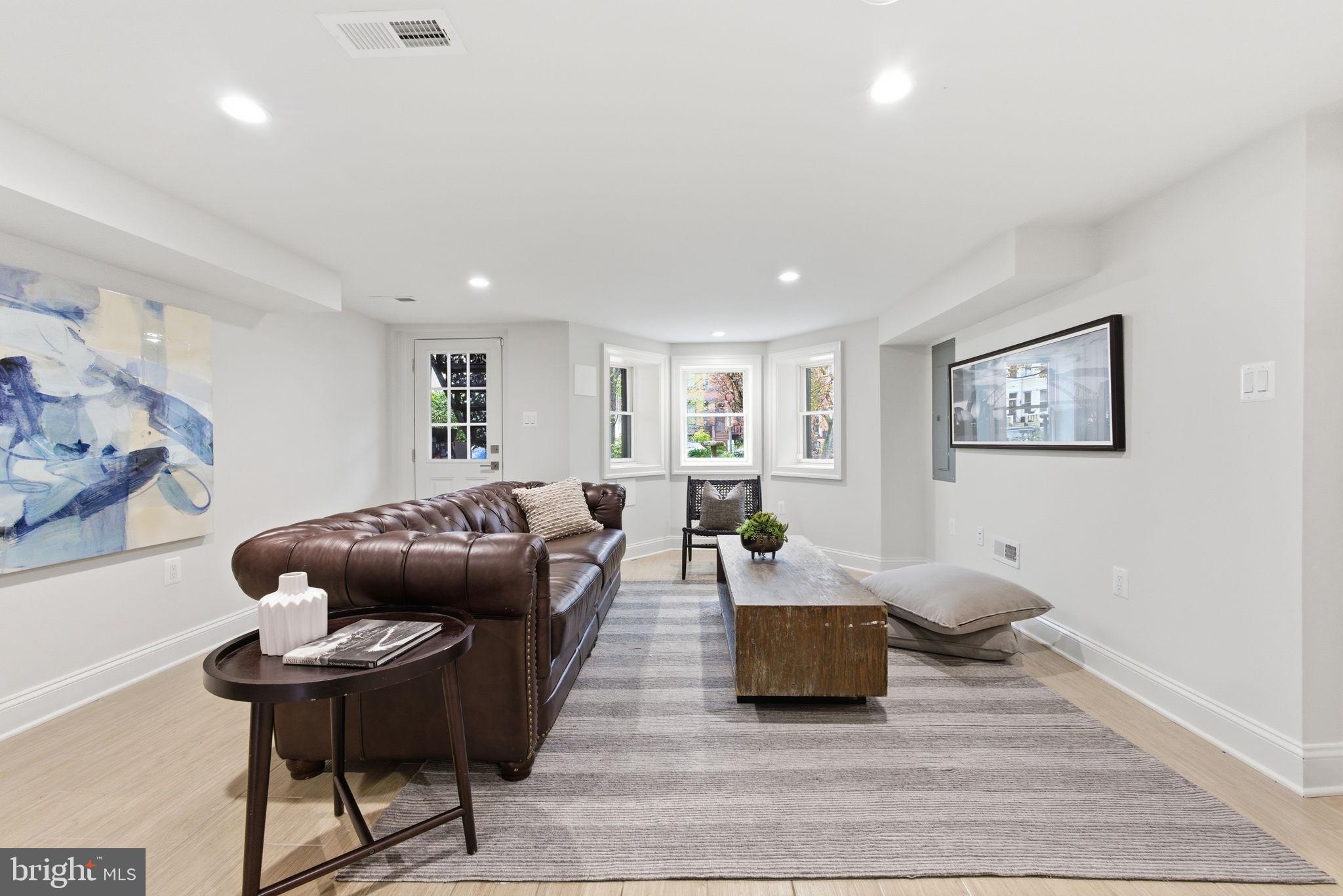 1319 East Capitol Street Southeast Washington, DC 20003 - Photo 31 of 46 a living room with furniture and wooden floor