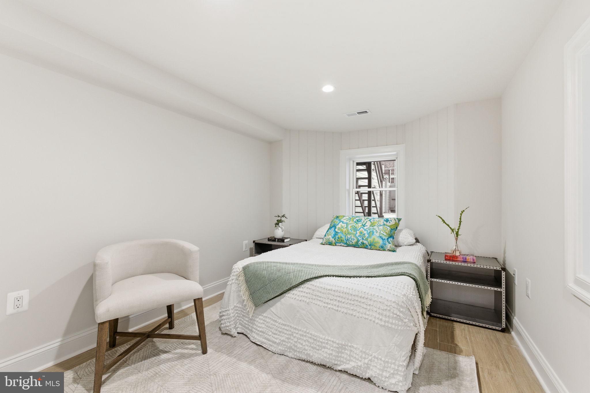 1319 East Capitol Street Southeast Washington, DC 20003 - Photo 34 of 46 a bedroom with a bed and a chair