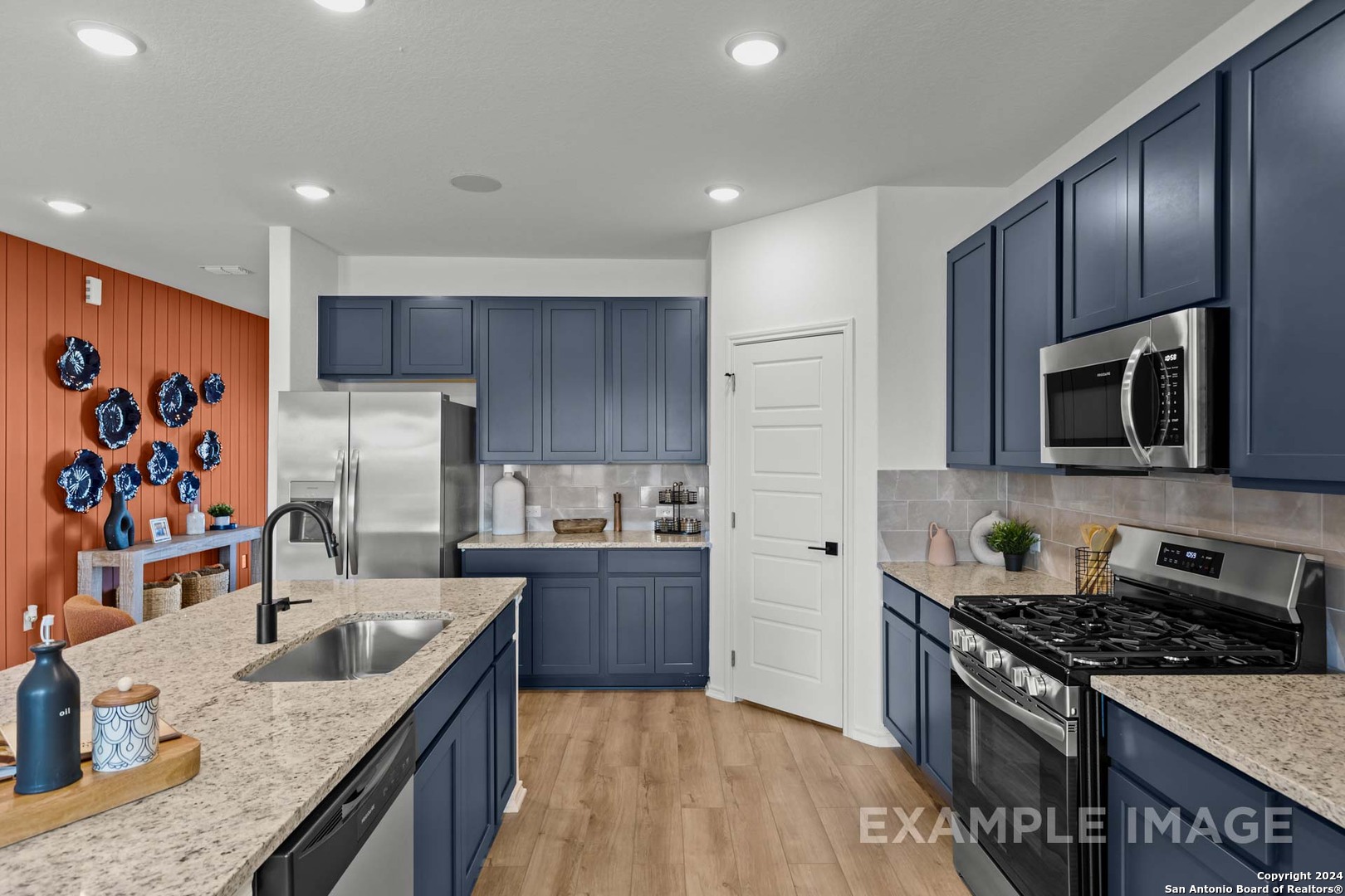 16603 Rosemary Ridge Elmendorf, TX 78112 - Photo 12 of 36 a kitchen with stainless steel appliances granite countertop a sink stove and refrigerator