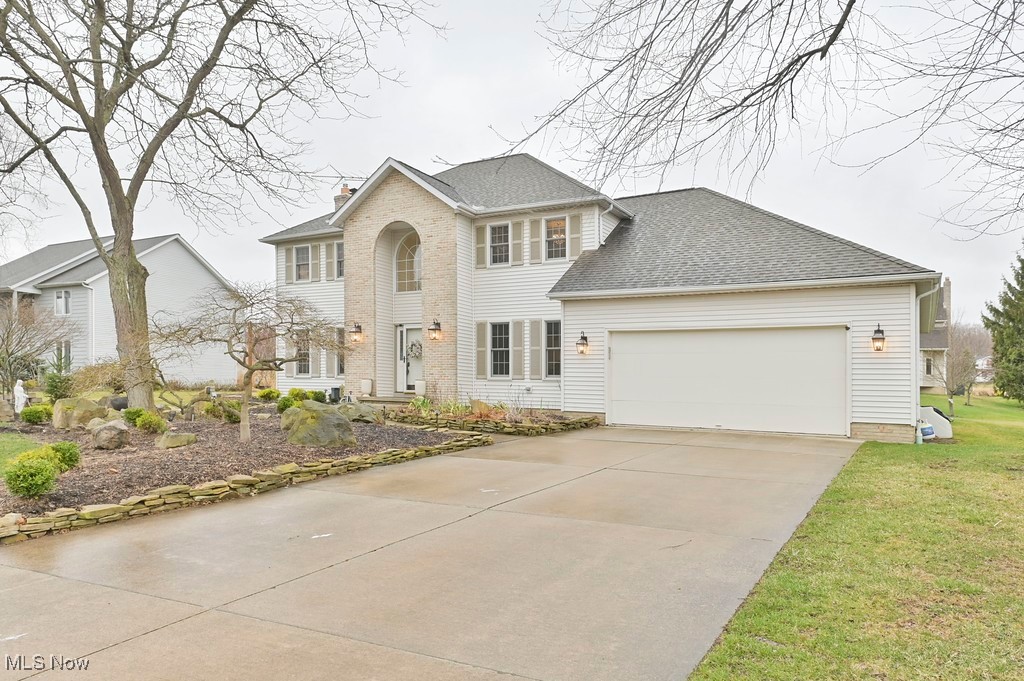 482 Longspur Road Highland Heights, OH 44143 - Photo 2 of 47 Colonial house with an attached garage, a chimney, a front yard, driveway, and a shingled roof