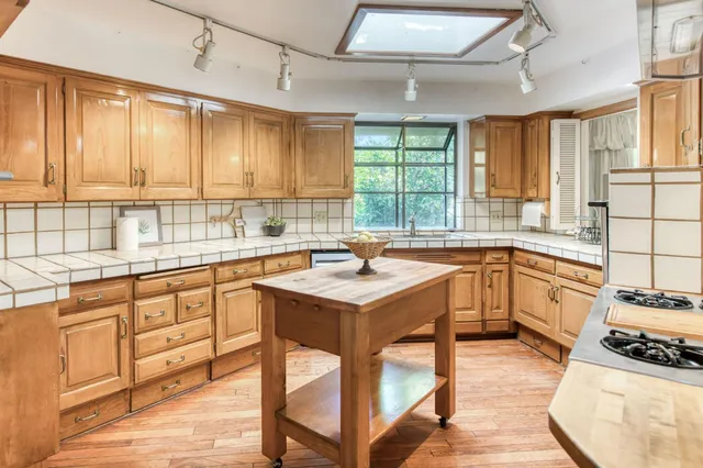a kitchen with a sink stove and cabinets