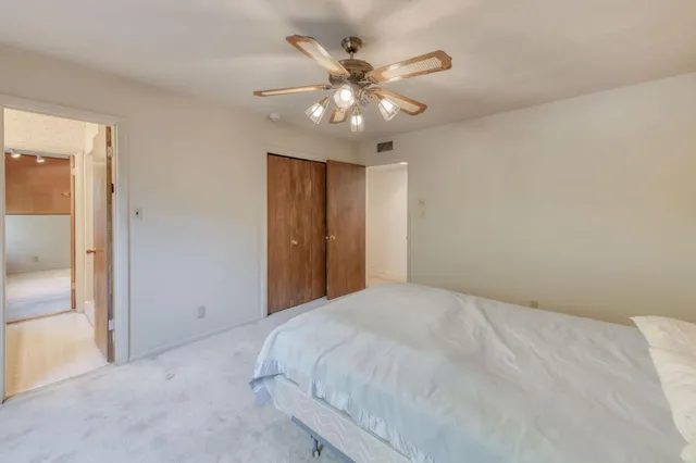 a bathroom with a granite countertop sink a toilet and shower