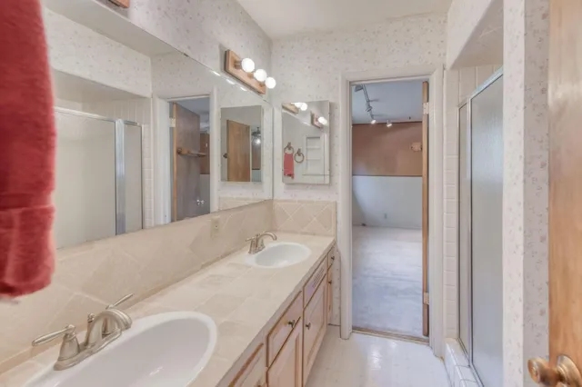 a bathroom with a sink double vanity and shower