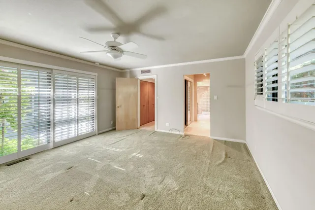 a backyard of a house with a yard and outdoor seating