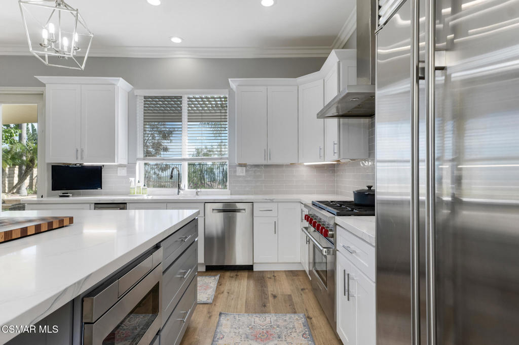 6140 Deerhill Road Oak Park, CA 91377 - Photo 11 of 72 a kitchen with a sink stove and refrigerator