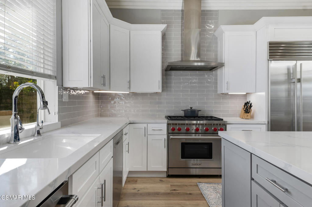 6140 Deerhill Road Oak Park, CA 91377 - Photo 12 of 72 a kitchen with granite countertop a stove sink and cabinets