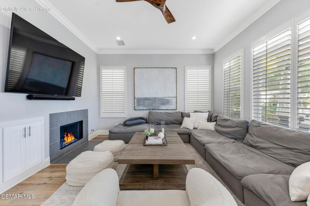 6140 Deerhill Road Oak Park, CA 91377 - Photo 15 of 72 a living room with furniture a flat screen tv and a fireplace